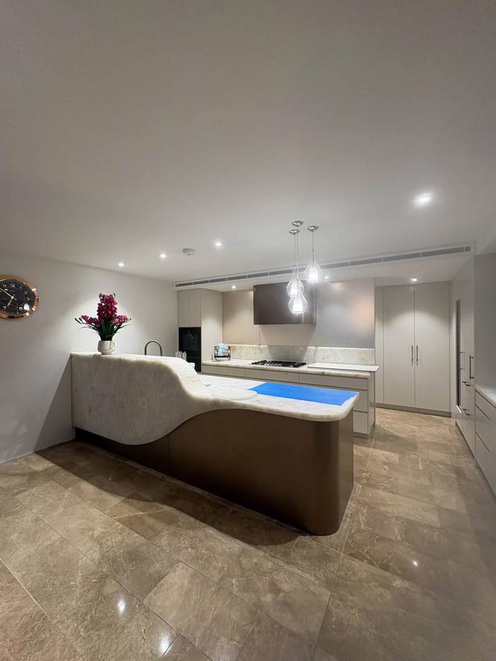 Kitchen with recessed downlights and glass pendants