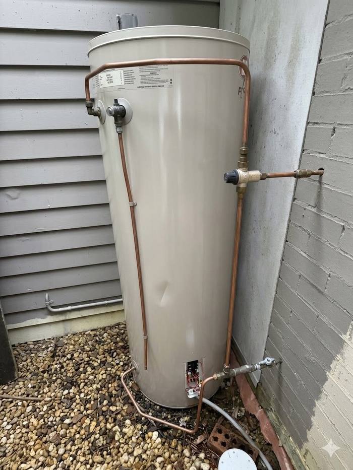 Electric hot water system installed outside a home